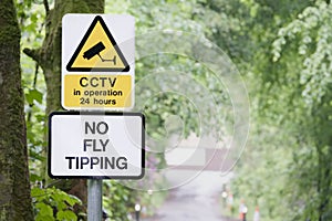 No fly tipping sign in beautiful landscape garden