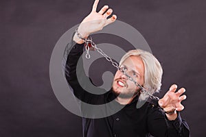 Furious man with chained hands, no freedom