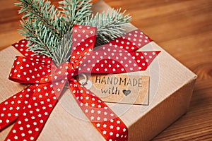 No Gift Christmas Ideas for Family, Friends For An Anti-Consumerist Christmas. Xmas gift kraft paper box with red ribbon