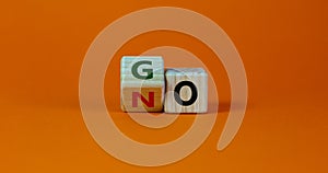 No or go symbol. Turned a cube, changed the word `no` to `go`. Beautiful orange background. Copy space. Business, motivation a