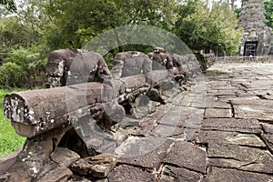 No head stone statues holding a hand rail over a bridge