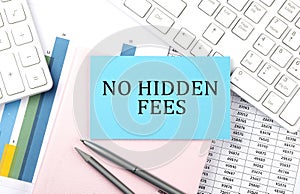 NO HIDDEN FEES text on blue sticker on chart with calculator and keyboard,Business concept