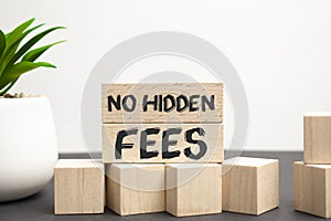 No hidden fees word written on wood block. No hidden fees text on wooden table for your desing, Top view concept