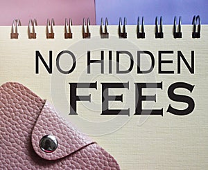 No hidden fees words on copybook page and pink wallet. Financial concept