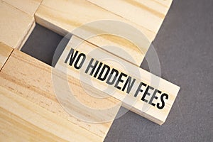 NO HIDDEN FEES words on wooden blocks on yellow background. Business ethics concept