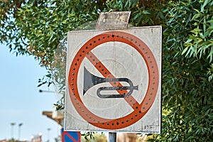 No horn sign in the city street. No honk and no noise for car photo