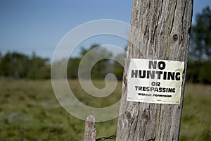 No hunting sign on post