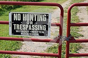 No Hunting or Trespassing Sign on Locked Gate