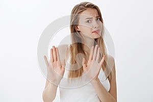 No I think refuse. Bothered displeased attractive popular female student showing rejection gesture with raised palms