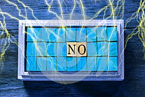 NO - isolated abstract in blue wood type stamps and lightning or thunder against wooden background and copy space