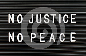 No justice no peace written on letter board.