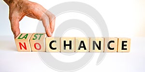 No or last chance symbol. Businessman turns wooden cubes and changes words `no chance` to `last chance`. Beautiful white