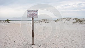 No lifeguards swim at your own risk sign in Pensacola beach, Florida.