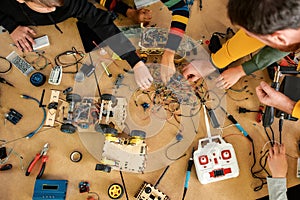 No Limits. Happy children working with wires, constructing diy robot in class. Smart kids and STEM education.