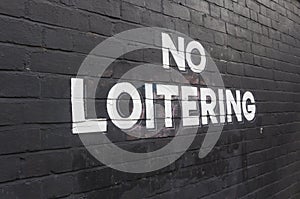 No Loitering sign painted on wall
