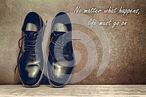 no matter what happens, life must go on, brown board and work shoes on wooden floor