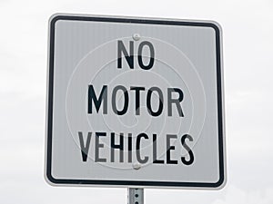 No motor vehicle sign in park photo