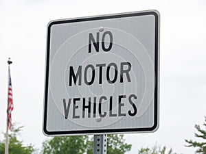 No motor vehicle sign in park with a USA flag on background photo