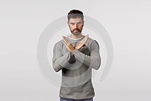 No, never accept it. Serious, confident bearded man in grey sweater, making cross stop gesture, restrict partner doing