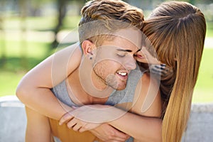 No one else in the world...a young couple sharing a tender moment together while enjoying a day in the park.