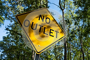No Outlet Road Sign near Wooded Forest