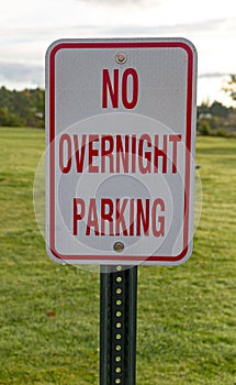 No Overnight Camping sign with a mowed lawn in the background