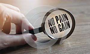 No Pain No Gain text concept with magnifying glass