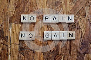 no pain no gain text on wooden square, motivation quotes.