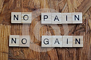 no pain no gain text on wooden square, motivation quotes.