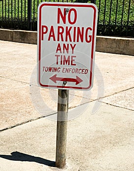 No Parking Any Time, Towing Enforced Sign in front of a Government Building