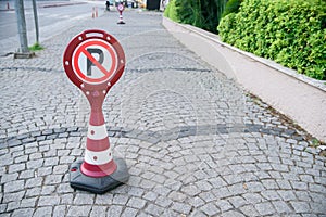 No parking sign cones at the pavement. Cars prohibited in pedestrian area.