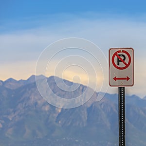 No Parking sign with mountain in the background