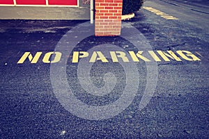 No parking sign on pavement in front of building