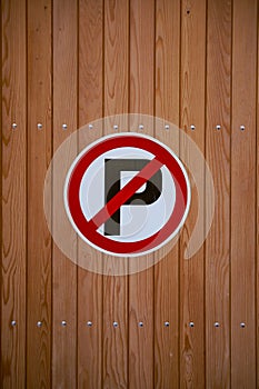 No parking sign on a wooden wall