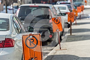 No parking signs next to parked cars