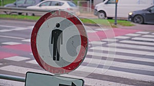 No Pedestrians Sign Blocking Zebra Crossing at Busy Street