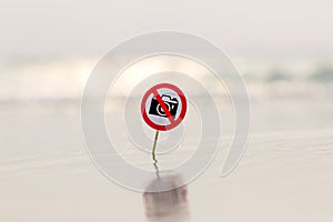 No photo sign on the beach