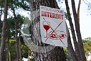 No picnic sign board on tree means in french text pique nique interdit