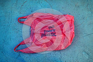 No plastic. Environmental awareness. Red plastic garbage bag with motto