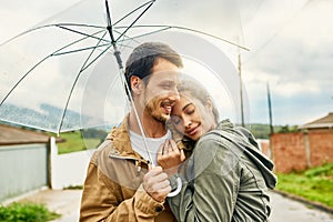 No relationship is all sunshine, rainy days will come. a loving couple standing outside with an umbrella.