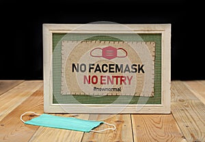 No Service without a face mask - new normal sign on wood table. Post pandemic life