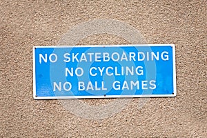 No skateboarding cycling or ball games sign on private property wall