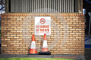 No smoking allowed sign at construction site entrance