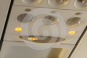No smoking notification signal light turns on inside passenger airplane cabin