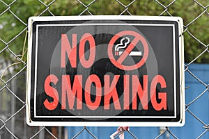 No Smoking Sign on a Construction Fence