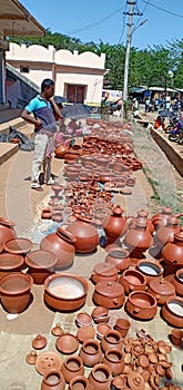Pooters with their pottery products in Koraput
