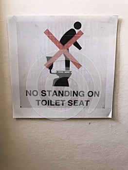 No standing on toilet seat sign