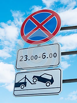 No stopping road sign against a blue sky