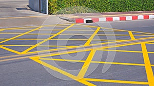 No stopping yellow crisscross zone traffic sign on asphalt road surface at the entrance and exit way of hospital