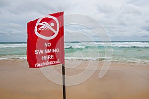No swimming here sign at the beach